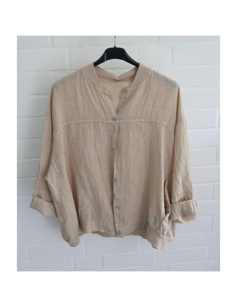 Beiger Damen Blusen-Blouson aus 100% Leinen auf schwarzem Kleiderbügel vor weißer Wand