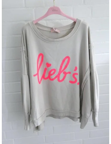Beigefarbenes Oversize-Sweatshirt für Damen mit neonpinkem lieb's.-Schriftzug auf Rosa Bügel