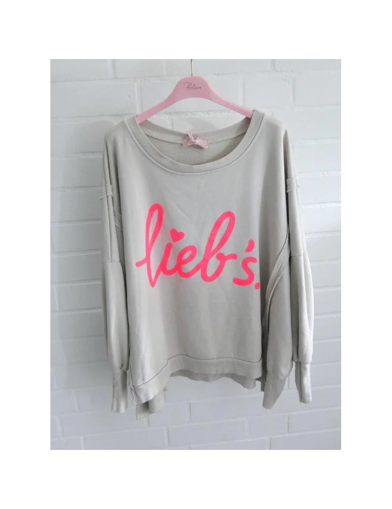 Beigefarbenes Oversize-Sweatshirt für Damen mit neonpinkem lieb's.-Schriftzug auf Rosa Bügel