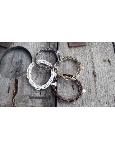 Verschiedenfarbige Gliederarmbänder auf Holzuntergrund