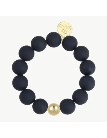 Armband mit matt schwarzen Perlen und einer goldfarbenen Perle auf weißem Untergrund