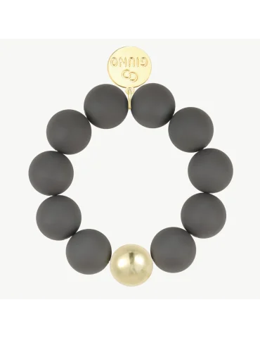 Armband mit grauen, matten Kugeln und einer goldfarbenen Kugel