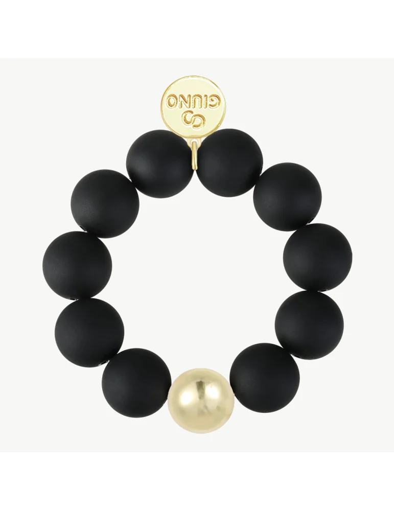 Armband mit schwarzen, matten Kugeln und einer goldfarbenen Kugel